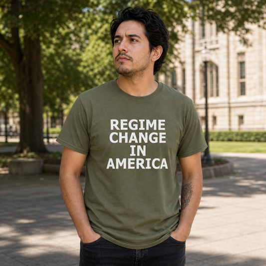 Man wearing the Regime Change in America olive T-shirt on a campus civic walkway